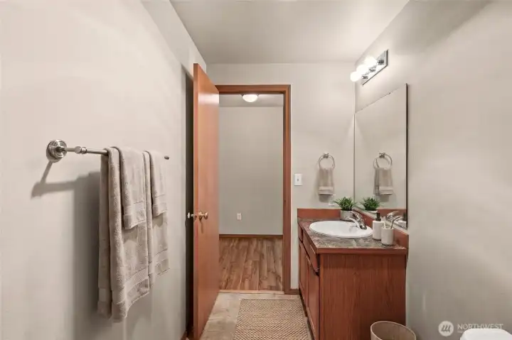 Half bath is off the entry and opens into the laundry room. Virtually staged! Half bath is off the entry and opens into the laundry room. Virtually staged!