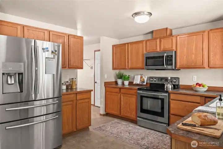 Virtually staged...Kitchen has abundant wood cabinetry and easy-to-maintain counters. Virtually staged...Kitchen has abundant wood cabinetry and easy-to-maintain counters.