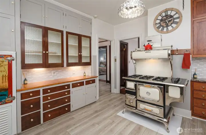 Original cabinetry and even the original Icebox at the far left of this photo.