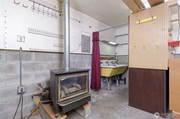 Woodstove and half bath in workshop.