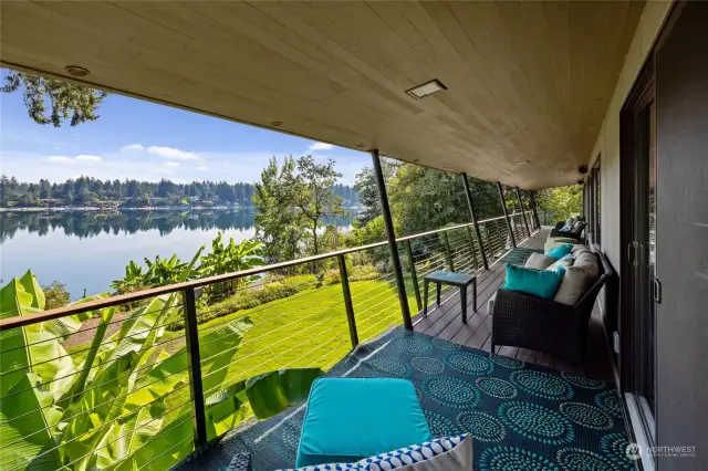 This Mid Century Modern home is wide to the Gravelly Lake & Mt Rainier views.  Covered rear deck spans the length of the home with dining area on the end.
