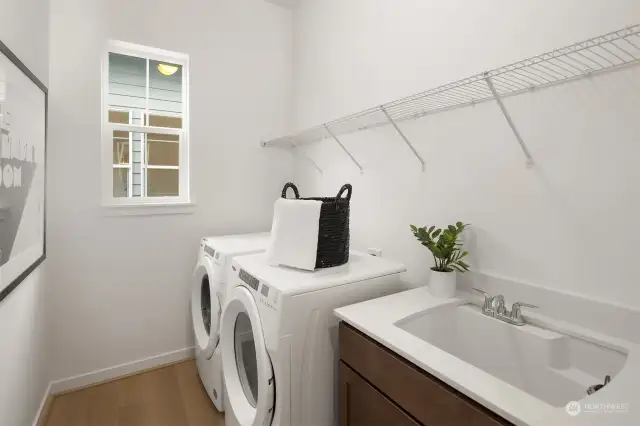 Laundry includes cabinet with sink