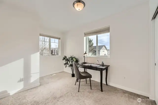 Bright, airy second bedroom has east and south facing views.