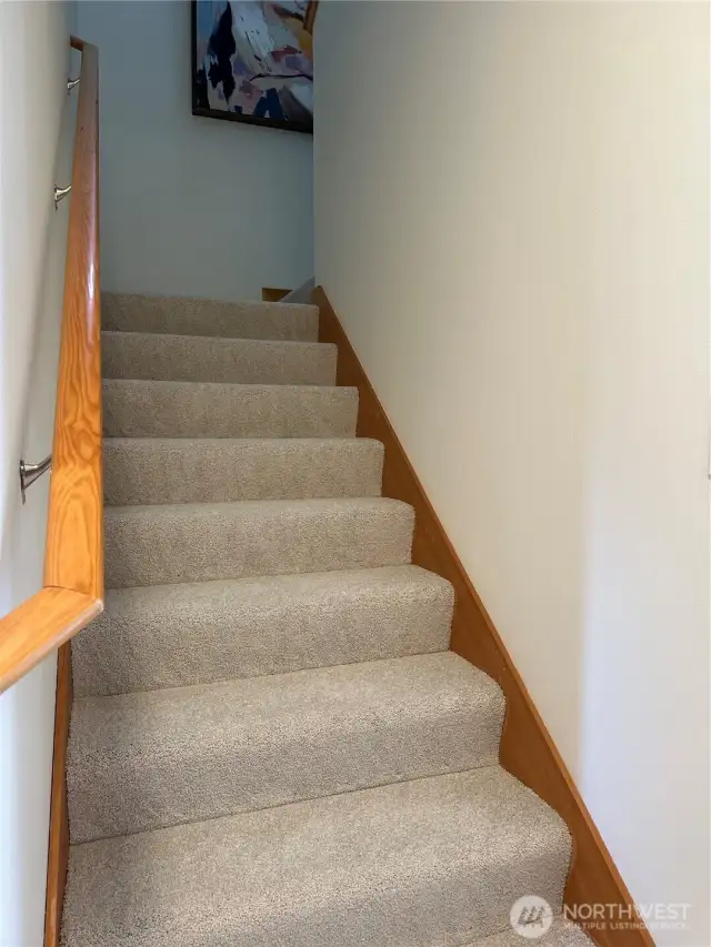Upstairs, you’ll find two comfortable guest bedrooms and a full bath, offering a private and versatile space for visitors, hobbies, or a home office.
