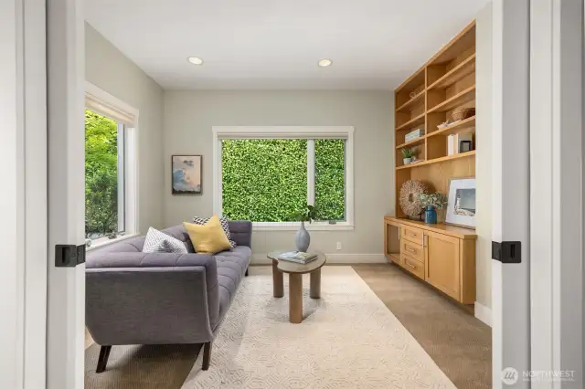 Behind the kitchen and off of the rear entry is the den. More built-ins and bookshelves are found in this flexible space.