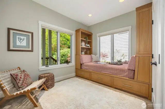 The main floor bedroom has a charming built in bed with large drawers beneath and two bookcases.