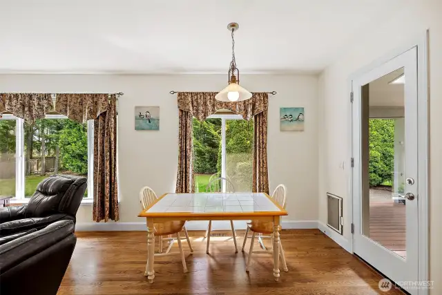 Breakfast nook off of kitchen and family room, with entrance out to covered deck