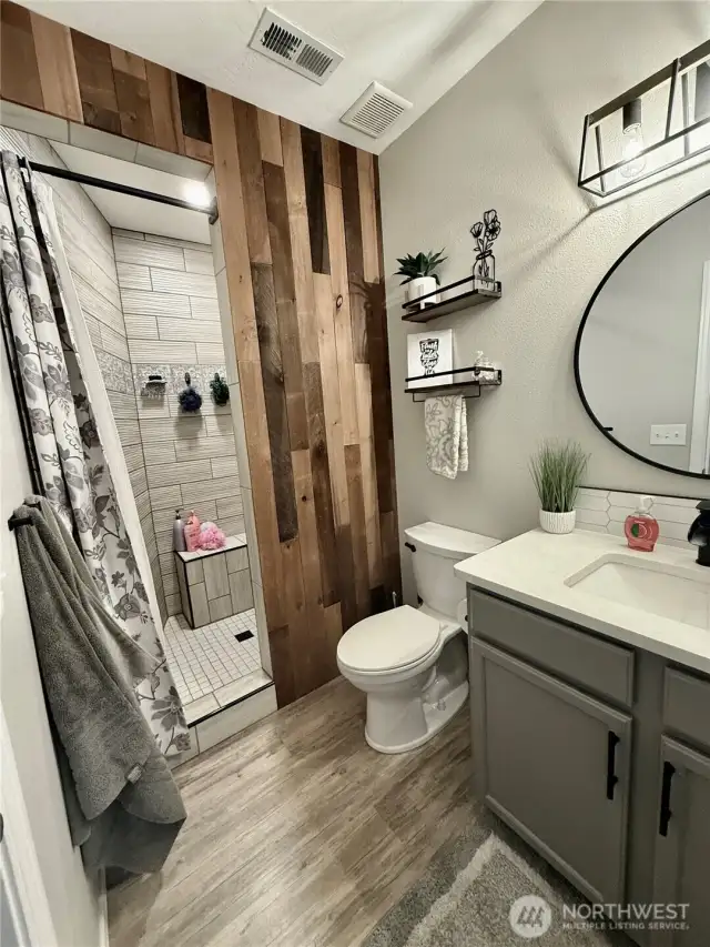 updated main floor full bathroom with new tiled shower