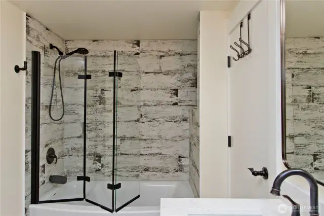 Primary Bath Shower/Tub with upscale folding glass door.