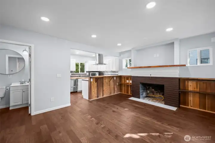Enter into the living room with open concept and gas fireplace setup