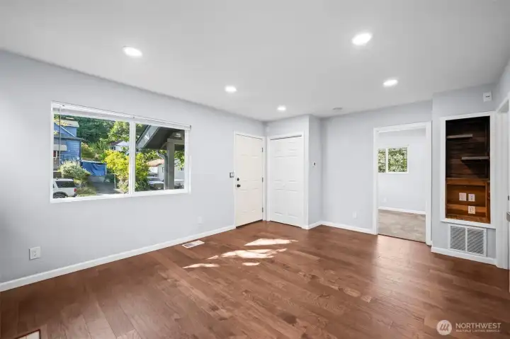 Looking back toward front door, coat closet and primary bedroom.