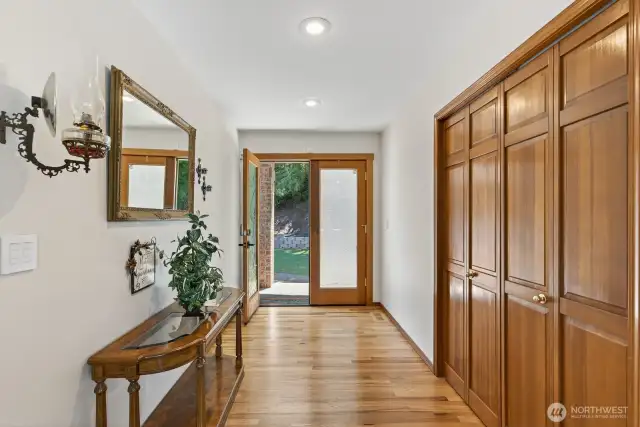 Wide entry way with frosted glass French doors leads into this beautiful home.  Large coat closet & sconce lighting.