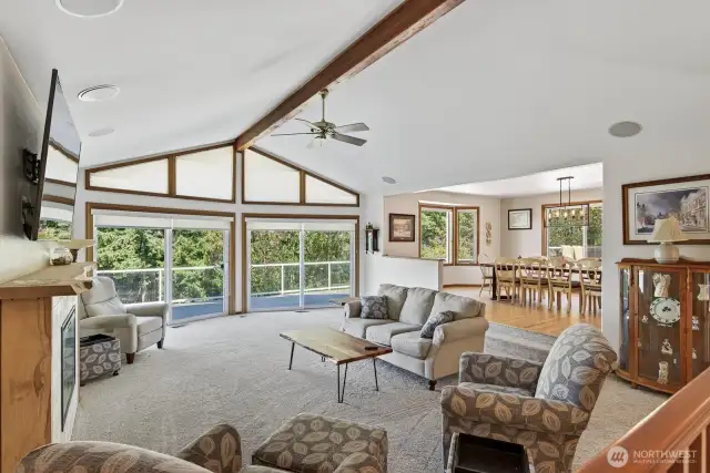 The great room with vaulted ceilings flows from the entry way. Huge sliding glass windows to catch a nice breeze off the water.  Built in speakers & brand new carpet all through out the home.