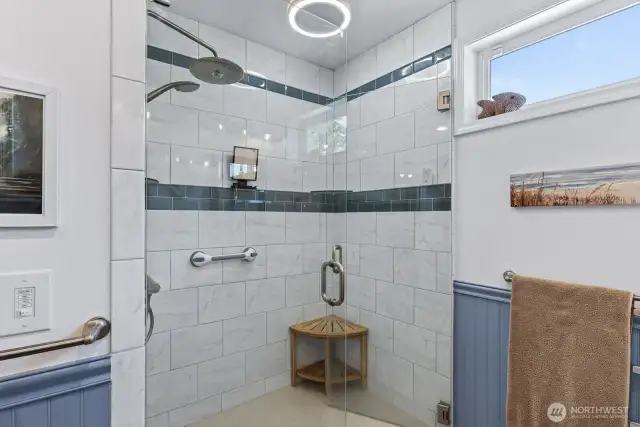 The walk in shower has beautiful tile work.