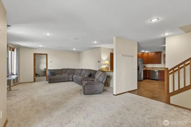 Large Rec Room down with tall ceilings and doors to more decks. There is no shortage of storage in this house!