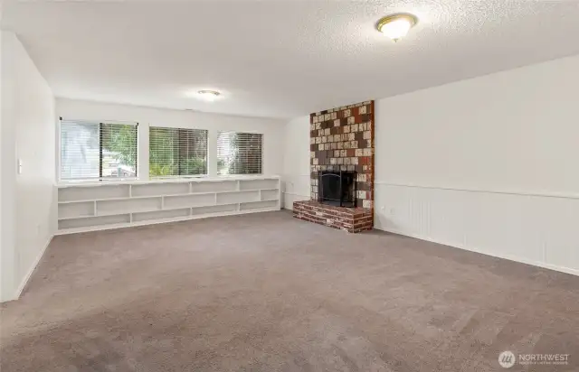 nice size bonus room with lots of light and wood buring fire place.