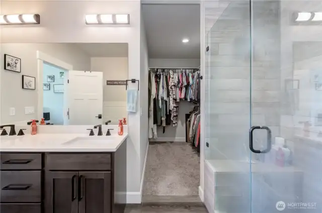 Extended walk-in closets featuring convenient built-in cubbies.