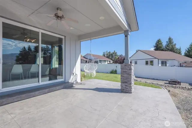 Relax outdoors on the covered patio with a ceiling fan and beautifully stamped concrete surface.