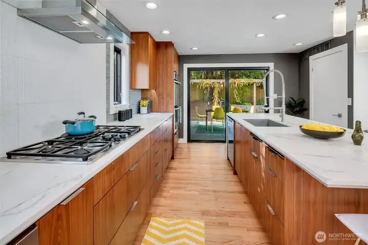 The well-lit kitchen has ample space to move about and a ton of storage drawers, cupboards & two pantry's.