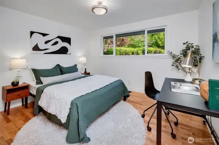 Spacious second bedroom with a large closet on the east side of the home shares a full tiled bath with the third bedroom.