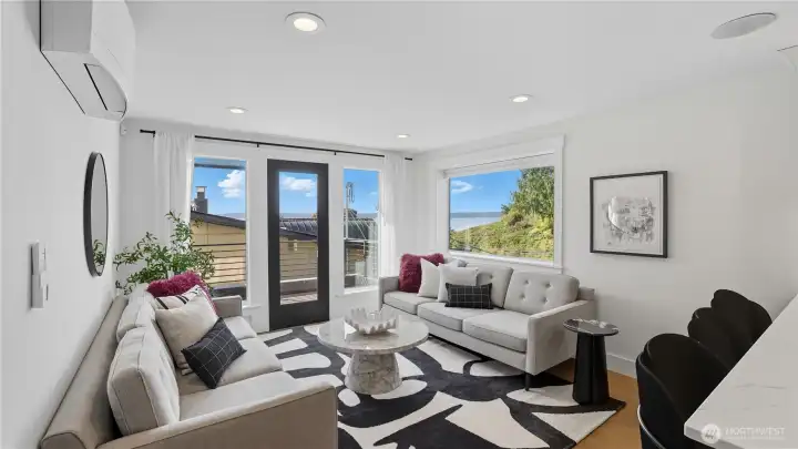 Light filled living room with lots of windows and a deck to take advantage of the views.