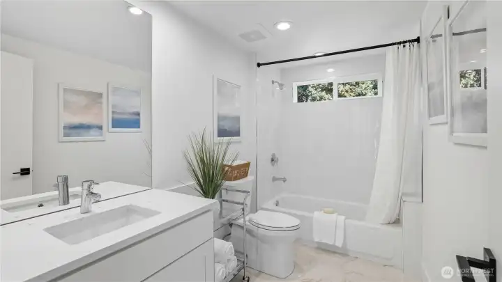 Full bath with tub/shower combo.