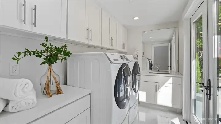Laundry room with built-in cabinetry for extra storage.