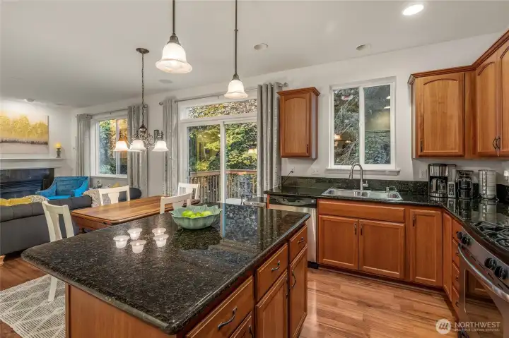 Kitchen island with breakfast bar and pendant lighting