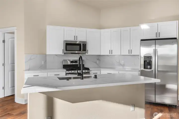 Enjoy hosting all your guests in this brand new kitchen! New cabinets, quartz countertops and backsplash.