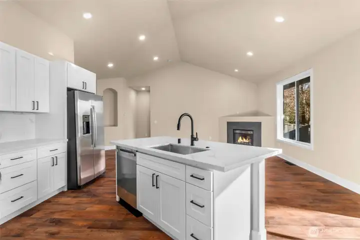 Kitchen island with serving counter and room to add seating on the other side.