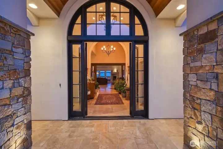 The floor is rare large tiles of tumbled limestone. The foyer serves as an art gallery as well as the areas that bridge each of the living spaces.