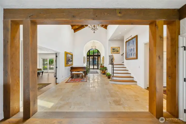 Light pours through arched windows, highlighting tumbled travertine floors and graceful transitions between levels. The chandelier is wired to lower for easy cleaning. There are 6 strategically placed outlets so that you can enhance your artwork.