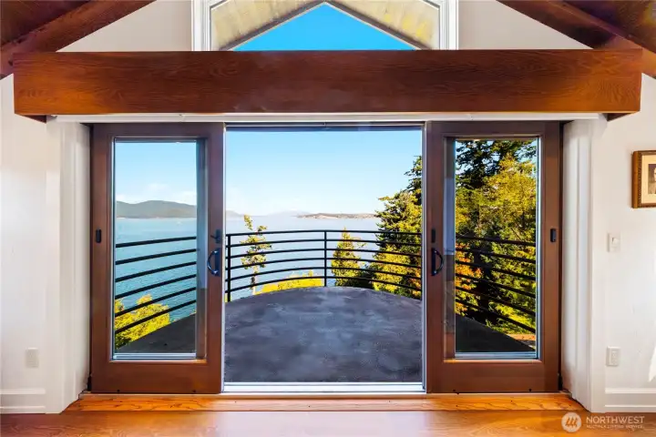 From the private executive office, a captain’s style balcony with vaulted wood ceiling and beams extends outward to sweeping island and mountain views.  This is on the third floor, accessible by elevator.  It has a private powder room and warming fireplace.