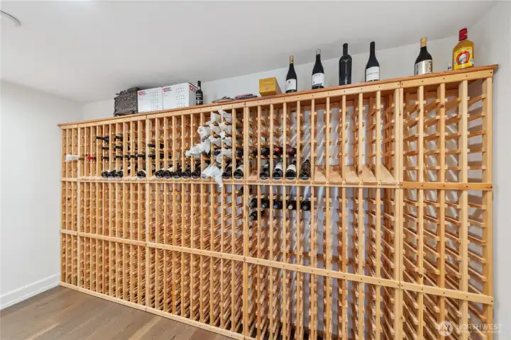 Dedicated wine room with floor-to-ceiling wood racking, offering generous storage for an extensive collection and convenient organization.