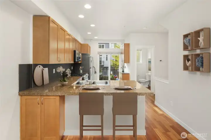 Chef kitchen opening to a charming Juliet-style balcony, ideal for morning coffee or grilling.
