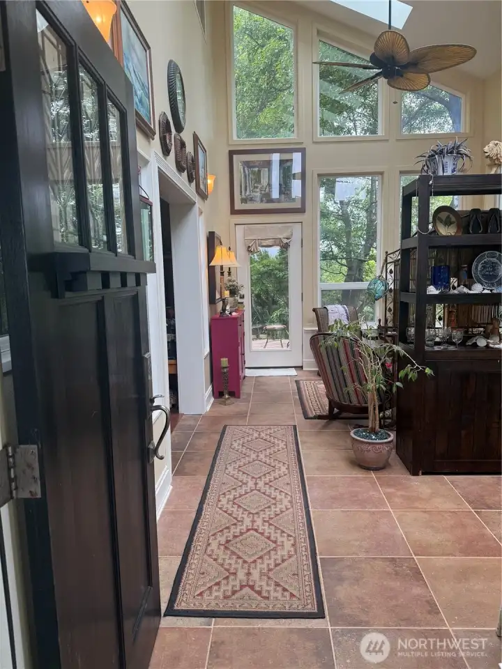 A grand entrance with five skylights and surrounded by windows. Porcelain tile floor for easy maintenance.