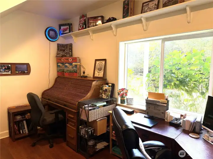 Off of the family room is an office or the 4th bedroom. Large window to watch wildlife and the waterfall. Door enters into the downstairs 3/4 bath.