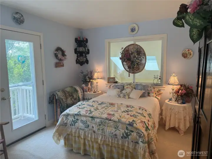 3rd Guest Bedroom with access to the wrap around deck and forest views. Window overlooking the Sunroom. 3rd Guest Bedroom with access to the wrap around deck and forest views. Window overlooking the Sunroom.