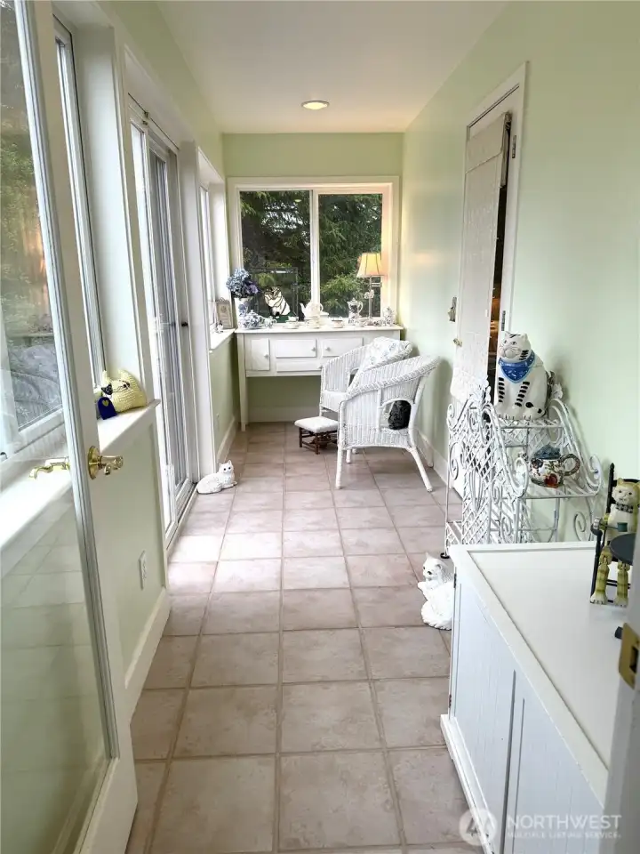 Sun porch with ocean view is a wonderful place to sit and watch the sunset over the ocean...maybe with a glass of wine. 2nd bedroom access. The sun porch has sliding glass doors to the deck. This room is surrounded by windows.