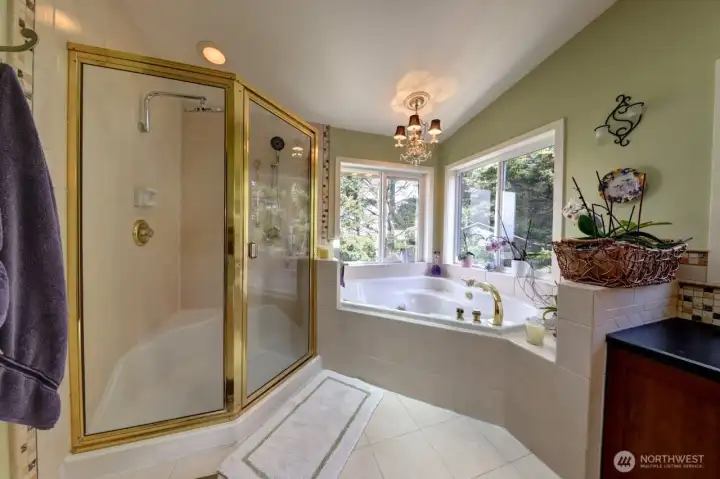 Primary bath has a water closet, large garden shower and jetted soaking tub with ocean views both from the water closet and the tub. Skylight not shown brings in lots of light. Primary bath has a water closet, large garden shower and jetted soaking tub with ocean views both from the water closet and the tub. Skylight not shown brings in lots of light.