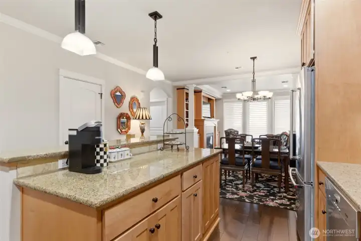 The kitchen is thoughtfully appointed with slab granite countertops, stainless steel appliances, New Double oven, a wine fridge, and under-mount lighting.