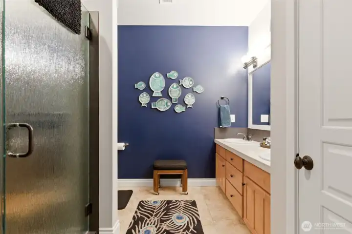 The color theme blends into the Primary suite bath with large new walk in shower with seat to relax in and get clean.