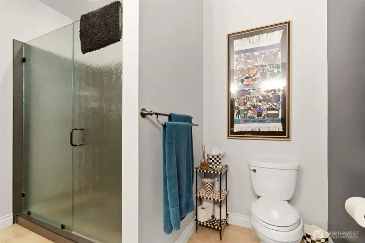 The color theme blends into the Primary suite bath with large new walk in shower with seat to relax in and get clean.