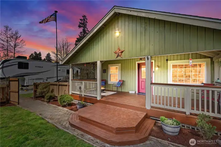 Charming covered front porch creates inviting curb appeal with a peaceful country setting—perfect for morning coffee and welcoming guests.