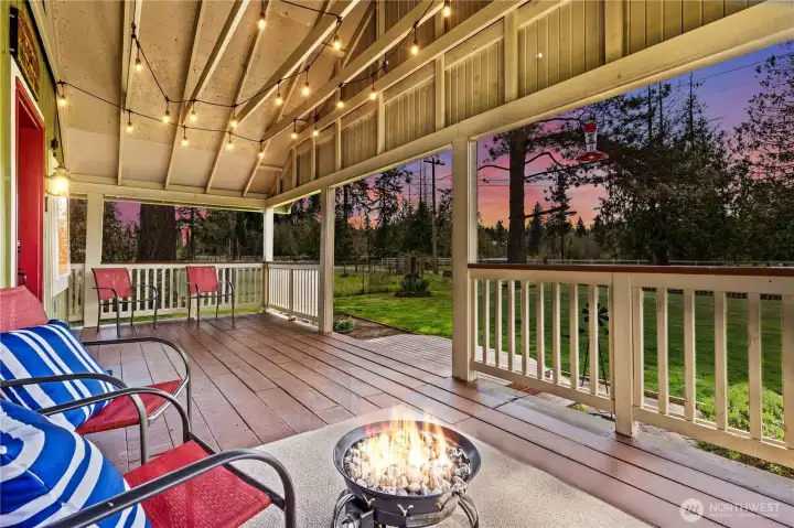 Covered outdoor living area with cozy seating—ideal for year-round enjoyment, gatherings, and taking in the serene rural atmosphere.