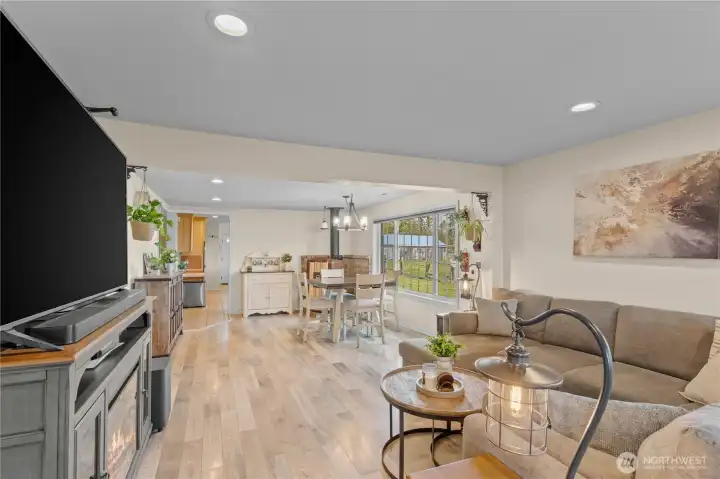 Spacious living room with open-concept design, modern flooring, and abundant natural light—ideal for relaxing or entertaining guests.