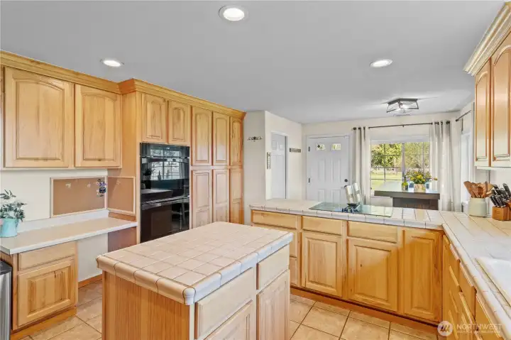 Additional kitchen view showcasing efficient layout, natural light, and easy flow into dining and living areas.