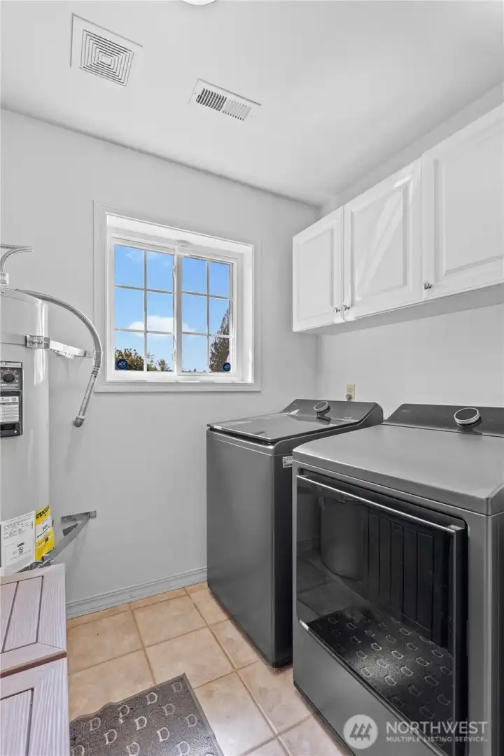 Dedicated laundry area with utility space and storage—ideal for maintaining an active country lifestyle.