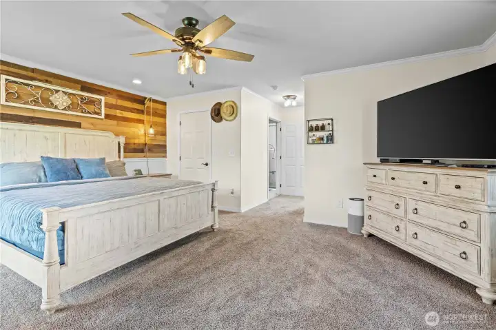 Large primary suite with room for additional furniture, creating a comfortable and private personal retreat.