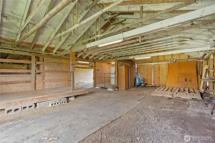 Interior of large barn featuring open layout and flexible space for livestock, storage, or agricultural use.